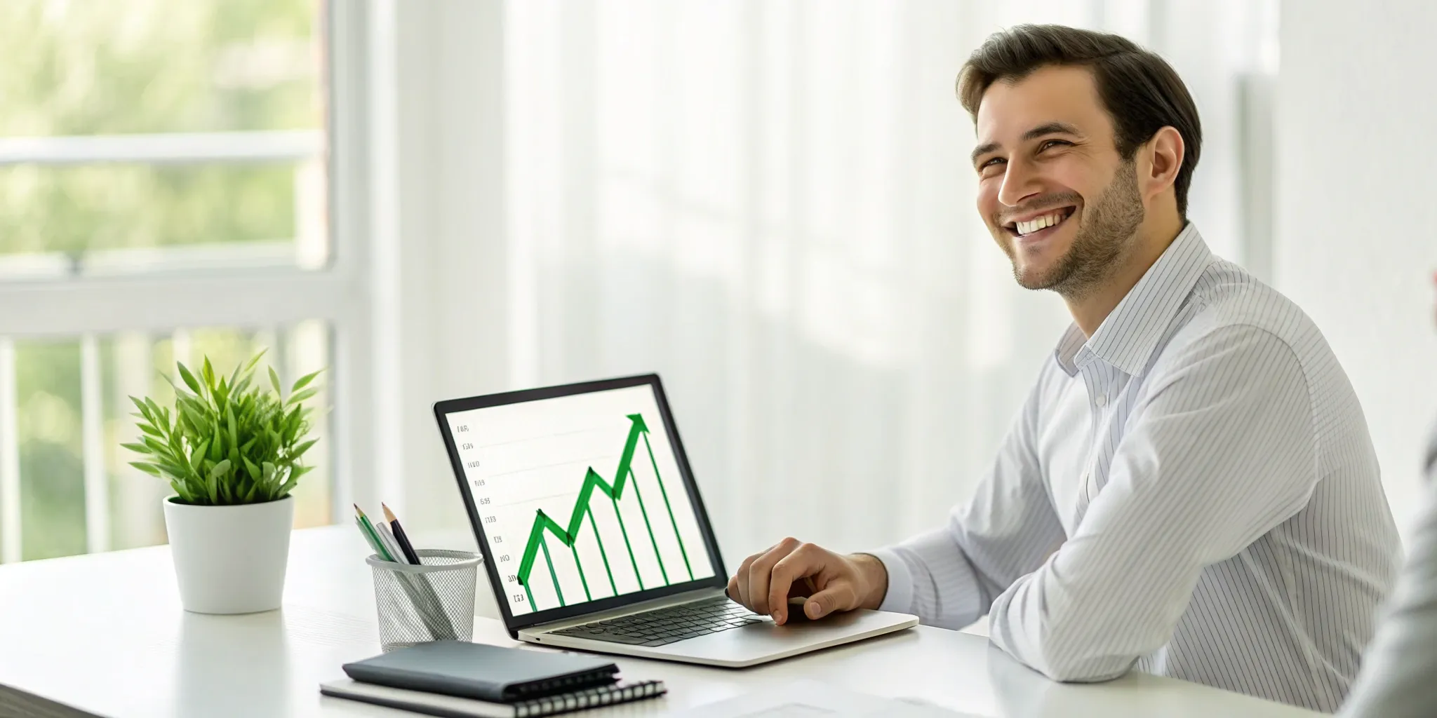 Man with laptop viewing rising graph. Improved credit score.