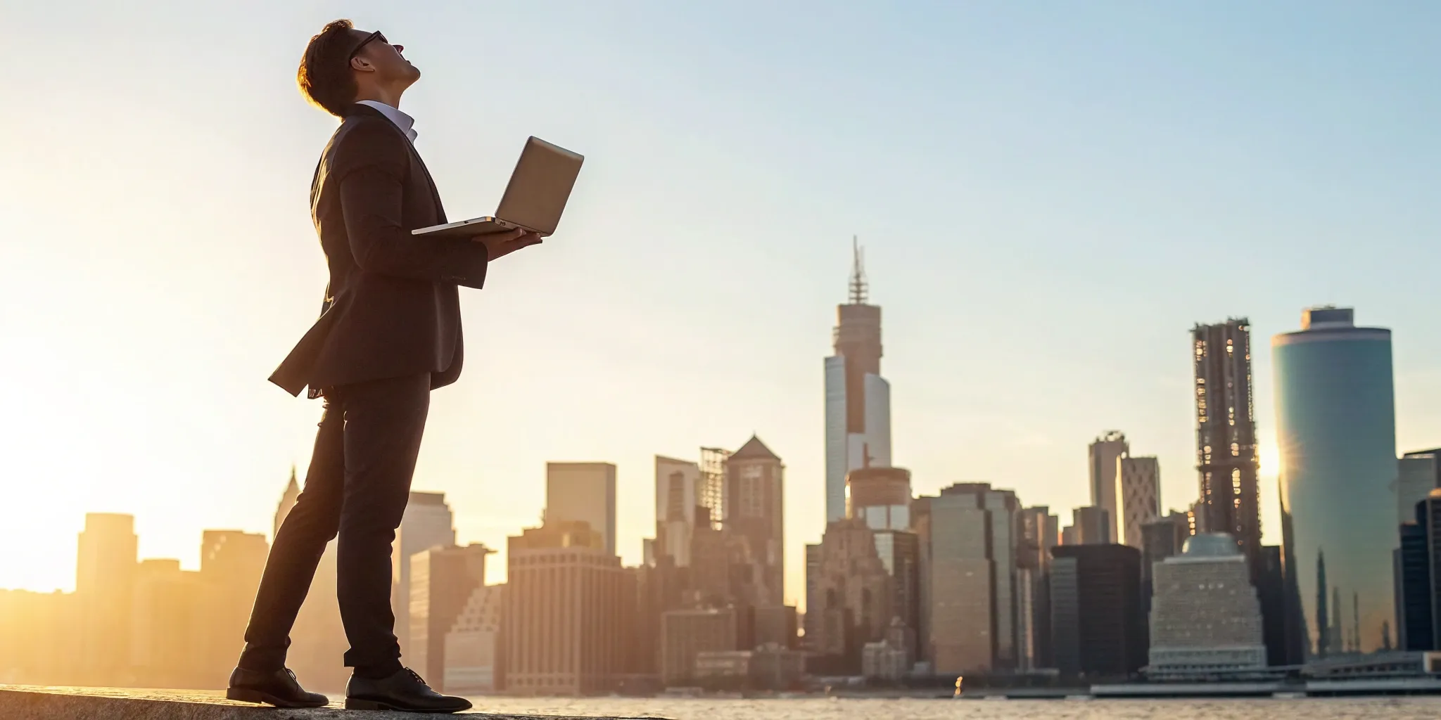 A founder researches startup business loans on a laptop with a city view.